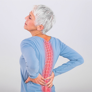 Elderly woman holding back, spine highlighted in red to show pain and inflammation